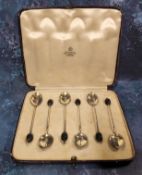 A set of six silver and enamelled coffee spoons, the backs enamelled in blue, bean terminals,