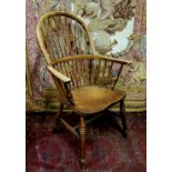 A 19th century ash and elm Windsor chair, spindle back, shaped seat, H stretcher, c.1850