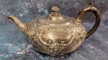 A George III silver teapot, embossed with flowers & scrolls on scale ground, ovolo rim, hinged