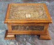 An Edwardian silver mounted and oak jewellery box, the cover and sides embossed with panels of