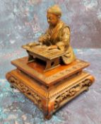 Japanese School, Meiji period,  dark patinated bronze, Scholar, seated at desk, 10cm high,