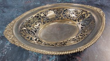 An Edwardian silver oval bread basket, part pierced decoration, with an upper gadrooned rim broken