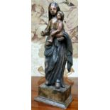 An 18th century Continental polychrome painted softwood carving of Madonna and child, 44cm high