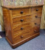 A Victorian fiddle back mahogany chest of two over three graduated drawers, plinth base