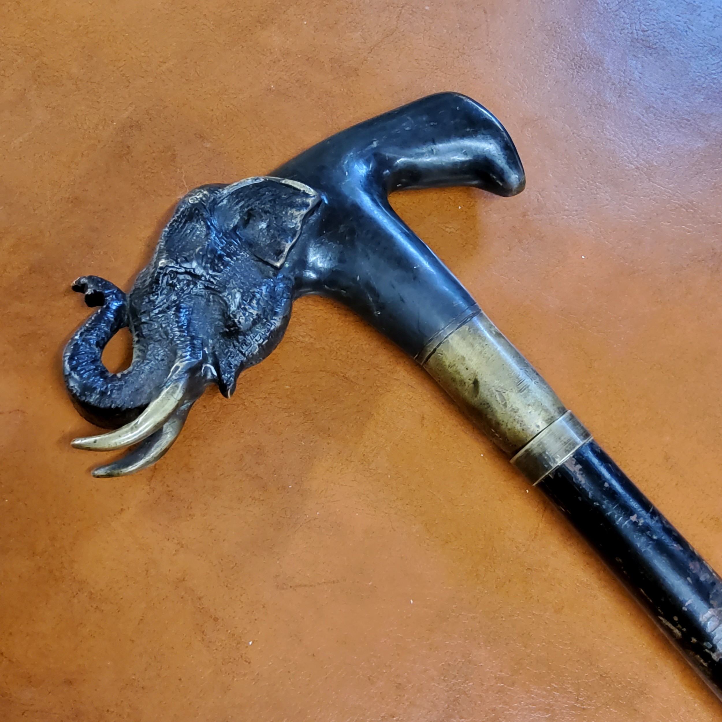 An Anglo Indian defence stick, the bronze handle cast with an elephant with trunk raised, ebonised - Image 3 of 4