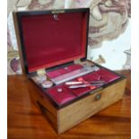 A Victorian rosewood  work box, fitted various covered boxes with silver plated dressing table jars,