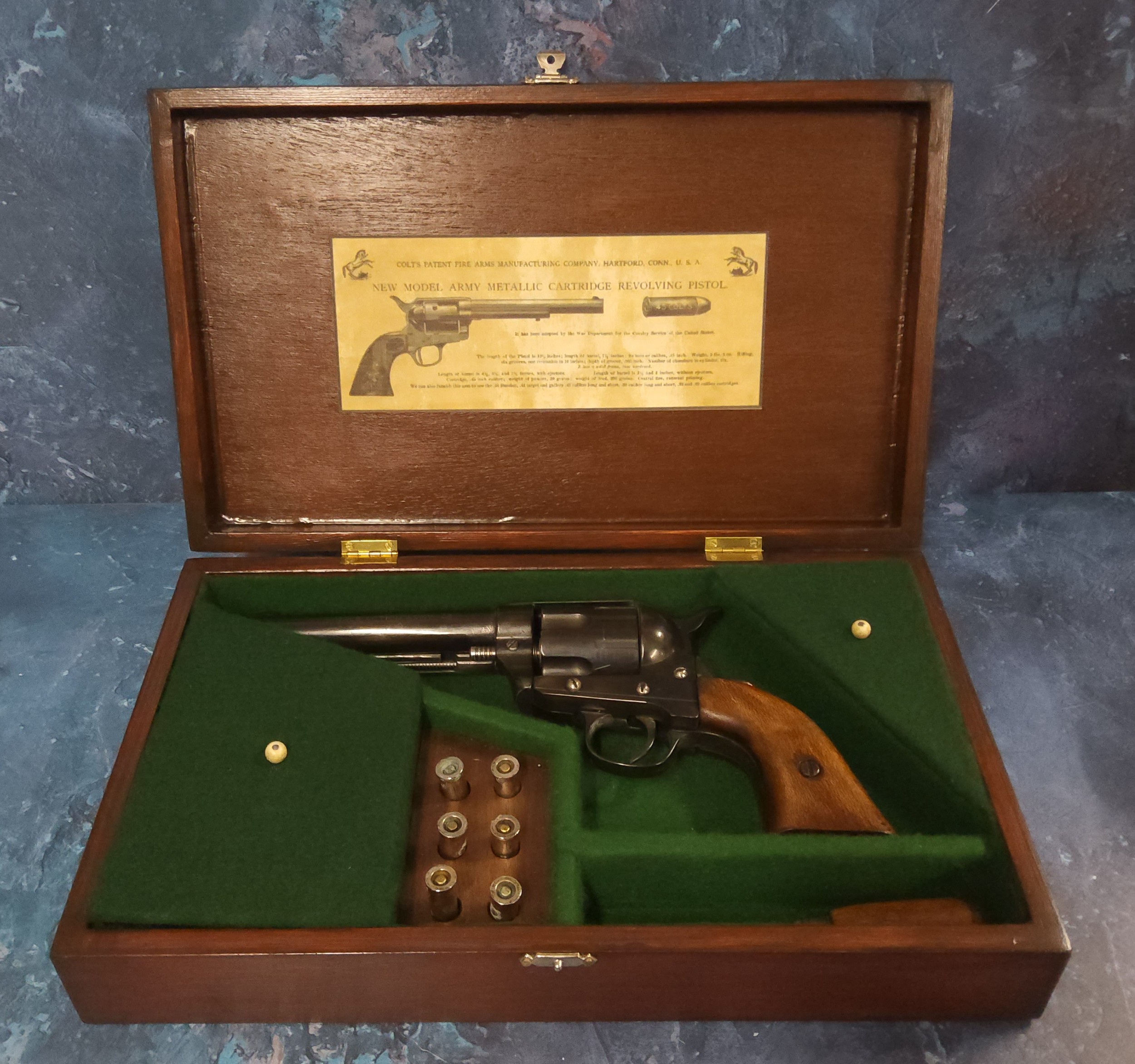 A replica Colt single action army .45 revolver, walnut grip, accessories including six reusable plug