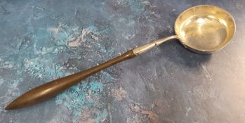 A 19th century silver coloured metal  toddy ladle, turned fruit wood handle, 39cm high, c.1780 -