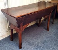 An early 19th century elm and fruitwood dough bin, rounded rectangular top, chipped carved edges,