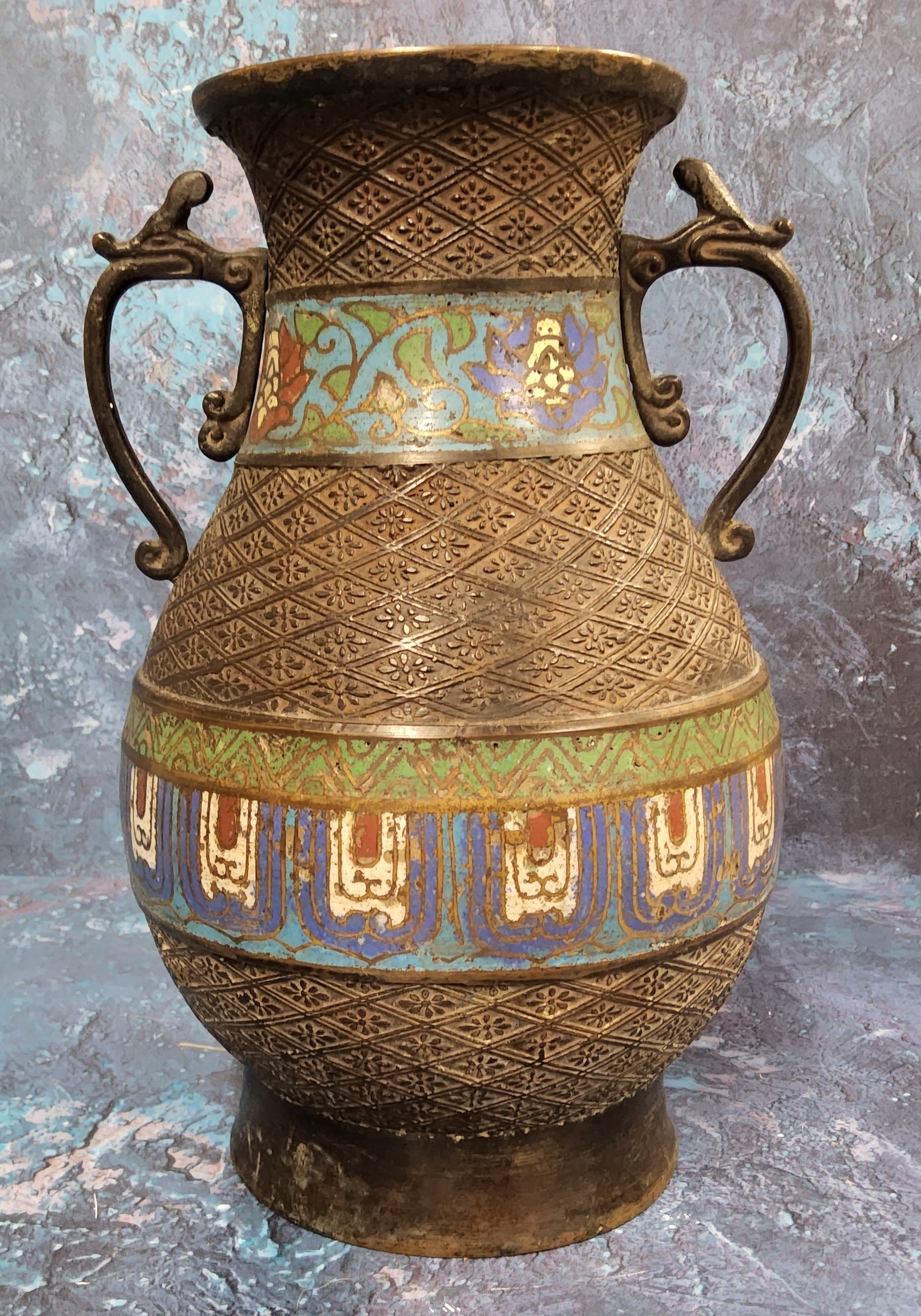 An early 20th century Japanese bronze and cloisonne two handled vase, banded with stylised flowers