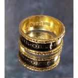 A George IV 18ct mourning ring, a 8mm wide the gold band with recessed black enamel centre with