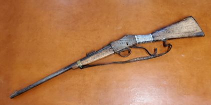 A 19th Century Martini Henry Carbine, steel barrel with copper barrel bands, the action faintly