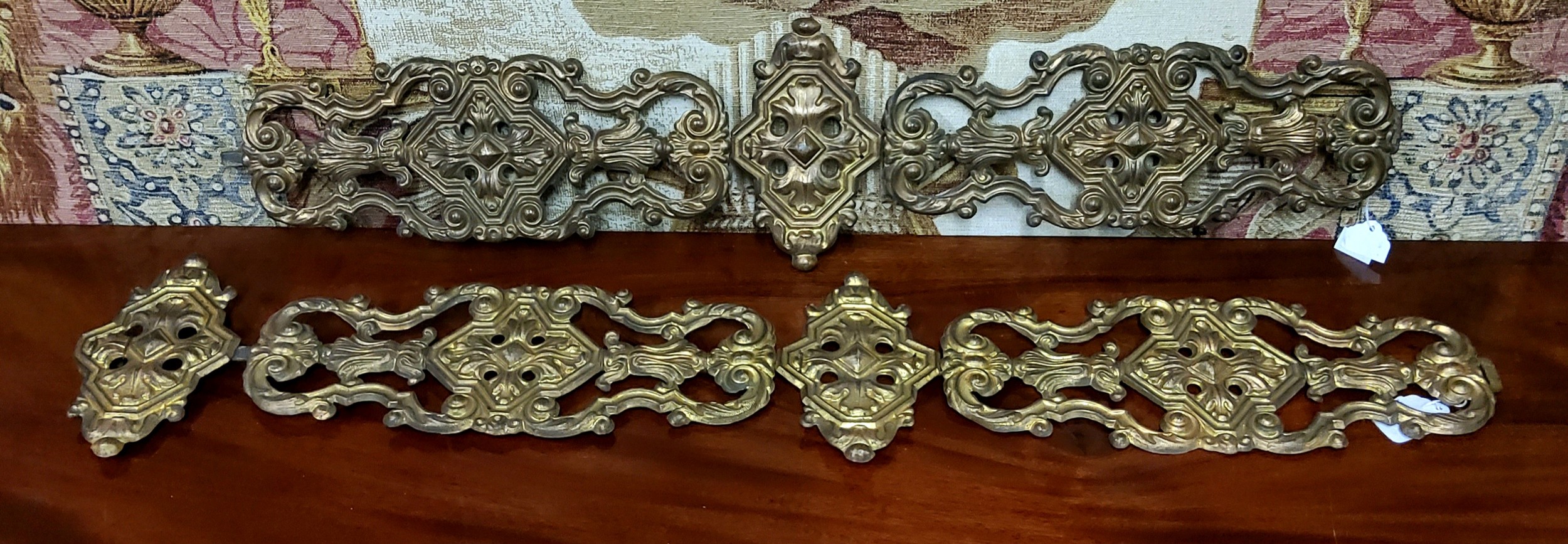 A pair of 19th century French embossed gilt sheet-metal appliqués/bell pulls, 90 cm in length (35½")