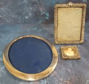 A George V silver oval easel photograph frame, 25cm high, 19.5cm high, Birmingham 1916; another,