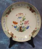 A Chinese Famille Verte plate, decorated with peonies, poppy and other foliage, the rim with
