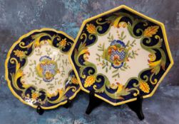 A Continental maiolica style octagonal plate, decorated with stylised foliage and scrolls, in