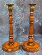 A pair of 19th century brass and oak candlesticks, knopped and turned columns, circular bases, 31.