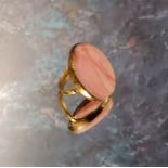 A 22ct gold and pink agate ring, set with an oval pink agate stone, 30 x 24mm, size N, 9g gross