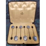 A set of six silver and enamelled coffee spoons, the backs enamelled in blue, bean terminals,