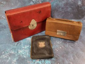 An early 20th century red morocco leather stationery case,  writing surface, stamp and paper pouches