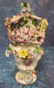 A Longton Hall vase and cover, of asymmetric shape encrusted with flowers, painted with rose and