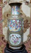 A large 19th century Cantonese Famille Rose vase, the cartouche panels decorated with figures