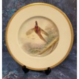 A Minton's circular plate, painted by J E Dean, signed, Pheasant, gilt banded border, 23cm diam,