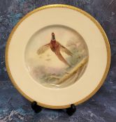 A Minton's circular plate, painted by J E Dean, signed, Pheasant, gilt banded border, 23cm diam,