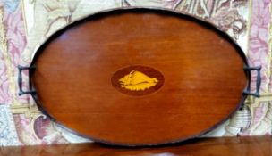 An early 20th century mahogany two handled gallery tray, inlaid with shell patera, wavy rim, 60cm