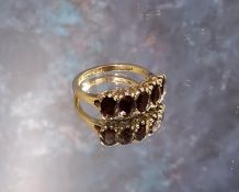 A 9ct gold five stone Garnet ring, size P, 3.67g gross