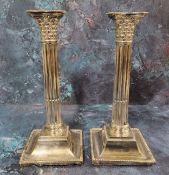 A pair of Edwardian silver Corinthian column candlesticks, detachable nozzles, stop fluted