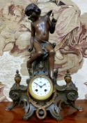 An early 20th century spelter figural mantel clock, surmounted with cherub, elaborate acanthus