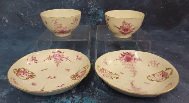 A pair of Worcester  tea bowls and saucers,  painted in Meissen style with puce camaieu flowers,