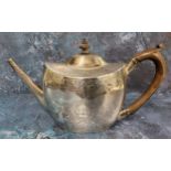 A George III silver oval teapot and cover, engraved with crest and initials, banded with fruiting