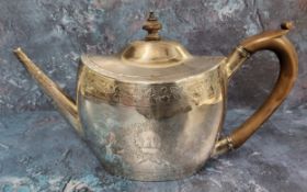 A George III silver oval teapot and cover, engraved with crest and initials, banded with fruiting