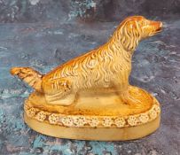 A Derbyshire salt glazed stoneware model, of a long haired dog, oval base, 14cm wide, c.1860