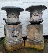 A pair of 19th century Armitage & Son garden urns, decorated in relief with foliate swags, on
