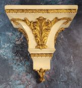 A 19th century painted oak wall bracket, applied with gilt scrolling leaves, leafy borders, 29cm