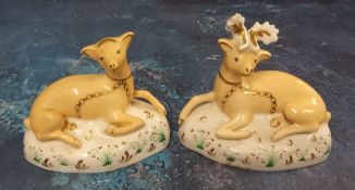 A pair of Staffordshire porcelainous models, of Stag and Doe, reclining, 9cm high, c.1860