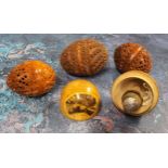 Three 19th century coquilla nut pomanders or flea catchers, each egg carved and pierced, largest