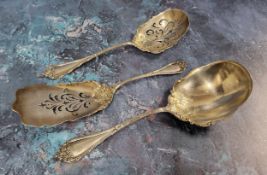 A Victorian silver gilt three-piece dessert serving set, each in relief with foliage, leafy ribbon