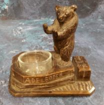 A 19th century Black Forest novelty table vesta/pin tray, carved with a standing bear, inscribed