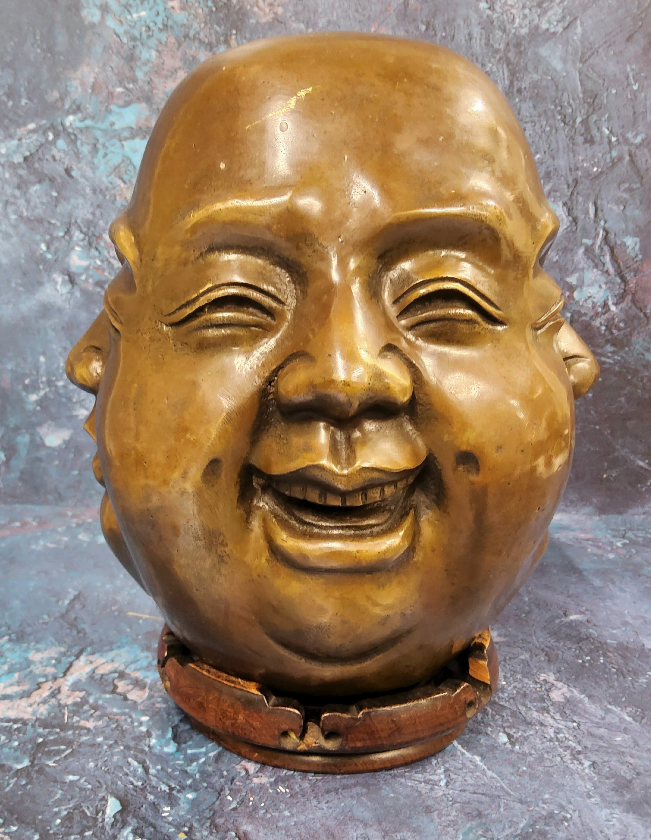 Chinese School, a brown patinated bronze, The Four Faces of Buddha, 24cm high, hardwood stand