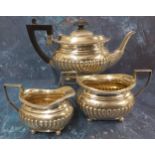A Victorian silver three piece half fluted boat shaped bachelors tea service, comprising teapot,