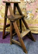An early 20th century metamorphic library chair, the hinged back splat folds to make a set of