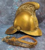 A Victorian brass Merryweather fireman's helmet, ornate high comb, applied with emblem, leather