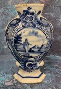 A Dutch Delft hexagonal vase, decorated in underglaze blue with figure and sailing boat, within