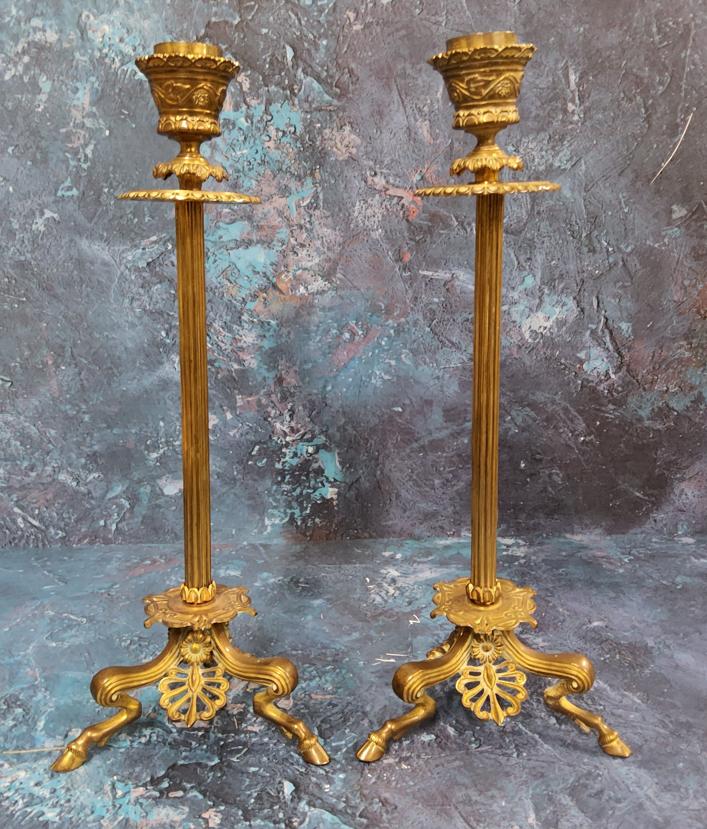 A pair of 19th century Barbedienne gilt bronze candlesticks, reeded columns, triform scroll legs,