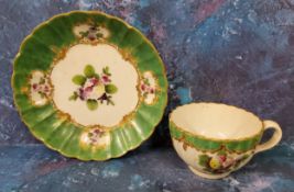 A Worcester fluted teacup and saucer, painted in a distinctive palette with sprays of 'Spotted