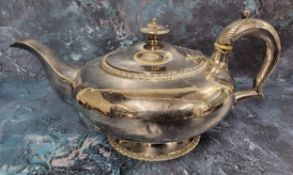 A George IV silver teapot, of compressed circular form, gadrooned border, acanthus scroll handle,